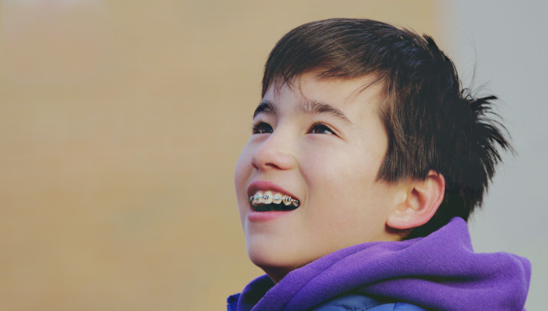 Child with braces smiling